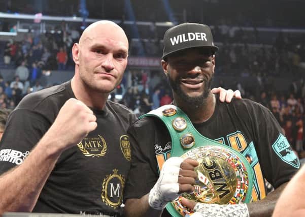 Tyson Fury, left, and Deontay Wilder share a photo afterwards. Picture: Lionel Hahn/PA