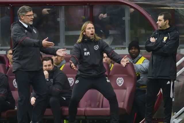 Craig Levein and Austin MacPhee appeal to fourth official Alan Muir. Picture: SNS