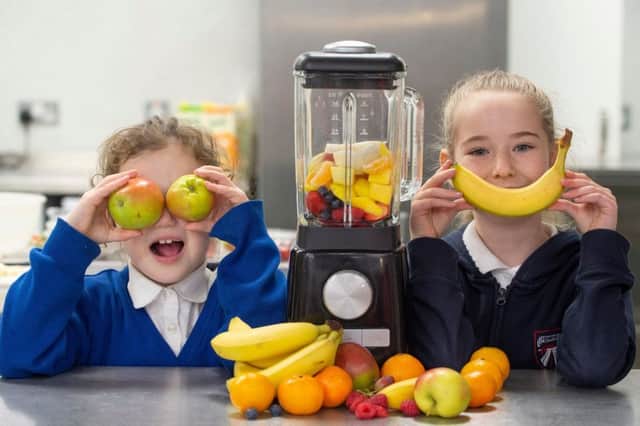 Primary four pupils Eva Juncal and Maci Suttie get to grips with making smoothies at the Fet-Lor Youth Club in Edinburgh