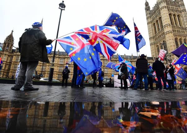 Anti-Brexit campaigners with Union and European Union flags outside the House of Commons in London. Picture: Victoria Jones/PA Wire
