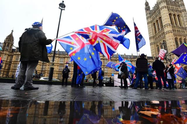 Anti-Brexit campaigners with Union and European Union flags outside the House of Commons in London. Picture: Victoria Jones/PA Wire