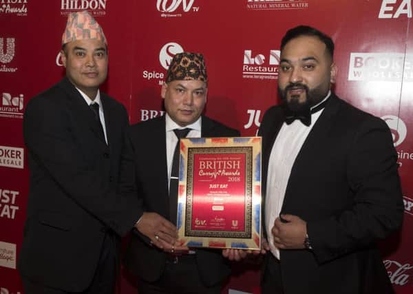 Pictured with the The Radhuni's award (left to right): Ashok Ram, front of house manager Rajesh Karki and Habibur Khan.