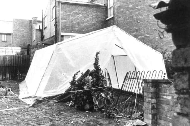 A tent erected by police hides part of the iron fence where the bodies of three young children were found in their Worcester home. Picture: PA Wire