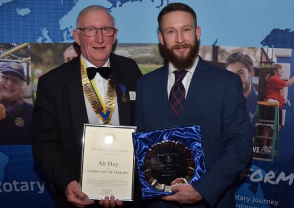 Ali Hay received his Citizen of the Year award from Kelso Rotary Club president James Mackie.