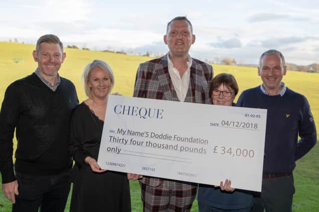 Stephen Gallacher, Susan Arkley, Doddie Weir, Jane Arkley and Robert Arkley at the cheque handover at Kingsfield Golf Centre. Picture: Kenny Smith