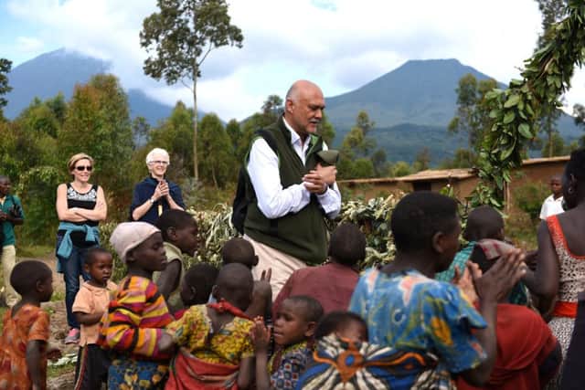 Founder of Volcanoes Safaris Paveen Moman and his wife at the opening of the Batwa Village,
Gahinga. Picture: Lisa Young