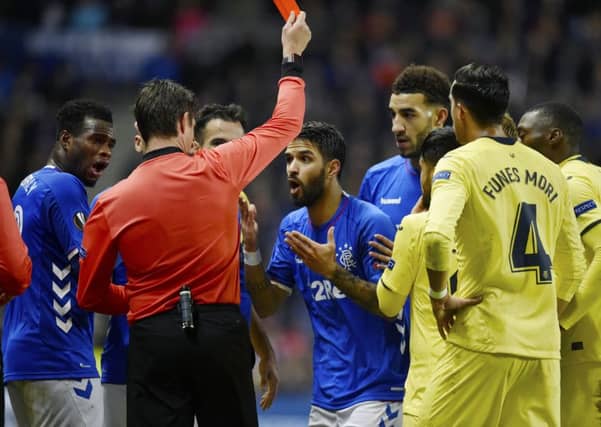Daniel Candeias is shown the red card against Villarreal, which prompted a fan to confront an assistant referee. Picture: SNS Group