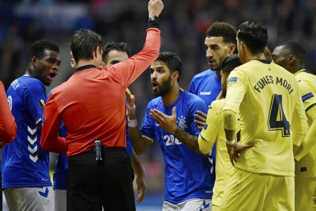 Daniel Candeias is shown the red card against Villarreal, which prompted a fan to confront an assistant referee. Picture: SNS Group