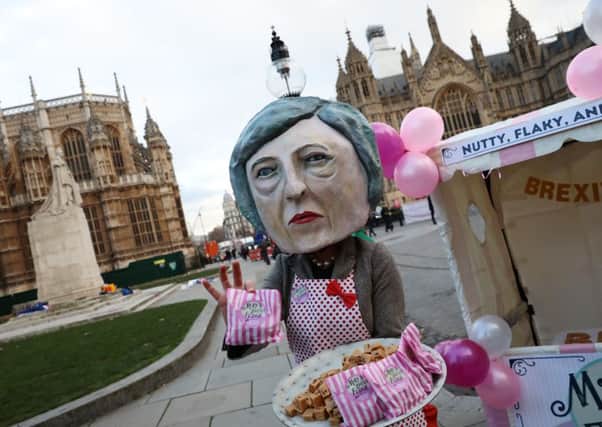 A protester dressed as a caricature of Theresa May hands out Mays Brexit Fudge (Picture: Picture: Dan Kitwood/Getty)