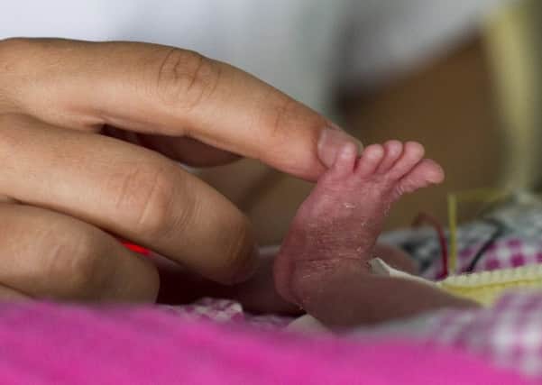 Baby loss charities are urging the NHS to improve inconsistent and under-resourced bereavement care for parents whose babies die shortly after they are born. Picture: FRED DUFOUR/AFP/Getty Images)