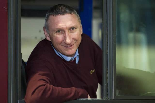 Clad in "burgundy", Ally Brazil is at home in his bus cab. Picture: Ian Rutherford