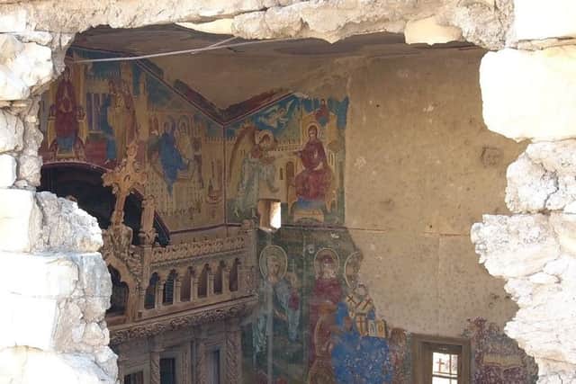 Shell damage exposes the frescoes of the Romanian church. Picture: Halo Trust