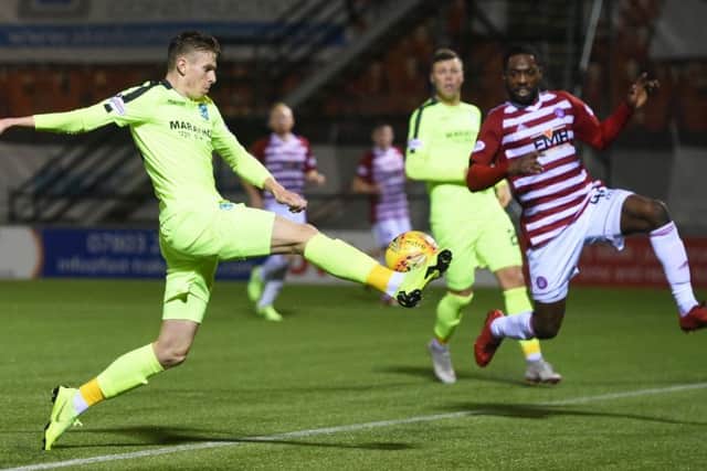Hibs striker Oli Shaw stretches out his right foot to score the only goal of the game against Hamilton. Picture: SNS.
