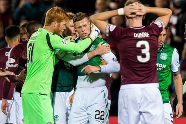 Adam Bogdan attempts to calm Florian Kamberi during the fiery Edinburgh derby on Hallowe'en. Picture: SNS Group