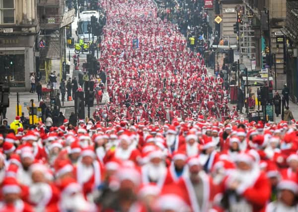 Over 8,000 members of the public took part in Glasgow's annual Santa dash. Picture: Getty Images