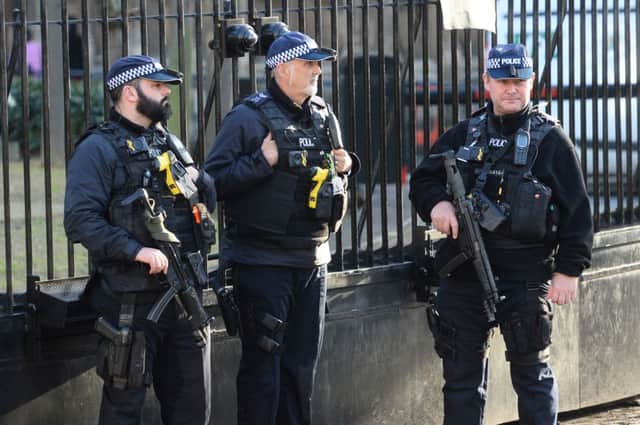 Armed police following an incident outside the Palace of Westminster