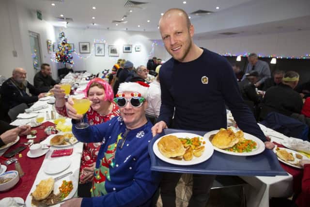 Steven Naismith helps the Loaves & Fishes charity, serving lunch to Glasgows homeless at Renfield St Stephen's Church Cafe. Picture: Ross Brownlee/SNS
