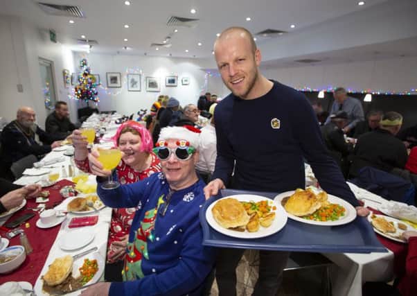 Steven Naismith helps the Loaves & Fishes charity, 
serving lunch to Glasgows homeless at Renfield St Stephen's Church Cafe. Picture: Ross Brownlee/SNS