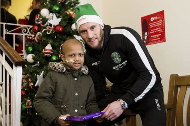 Hibs captain David Gray with Nusrat Jakan, six, at the Royal Hospital for Sick Children yesterday. Picture: Bruce White/SNS