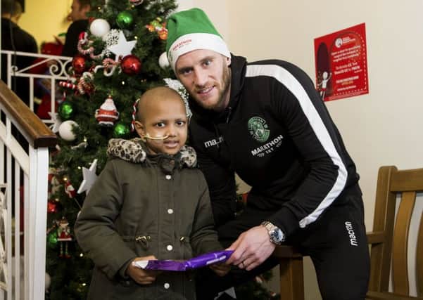 Hibs captain David Gray with Nusrat Jakan, six, at the Royal Hospital for Sick Children yesterday. Picture: Bruce White/SNS