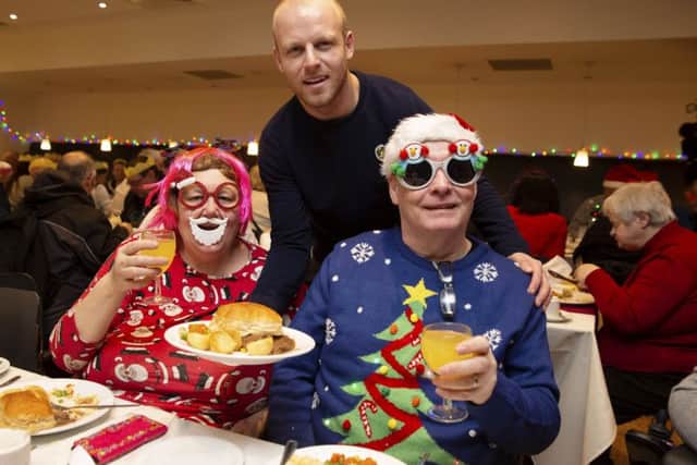 Hearts' Steven Naismith teams up with Glasgow charity Loaves & Fishes to help the city's homeless.

 He is pictured with Linda and John. Picture: Ross Brownlee/SNS
