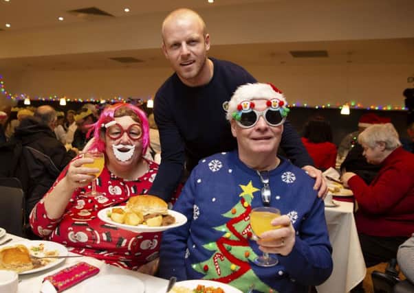 Hearts' Steven Naismith teams up with Glasgow charity Loaves & Fishes to help the city's homeless.

 He is pictured with Linda and John. Picture: Ross Brownlee/SNS