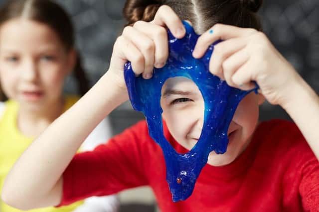 Children playing with the blue slime being sold by major UK toy retailers