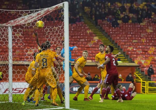 Aberdeen's Lewis Ferguson, right, is grounded after his late winner. Picture: Alan Harvey/SNS