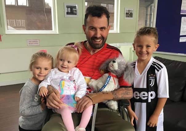 David Braham pictured with his children as he recovered from a curry induced paralysis. Picture: SWNS