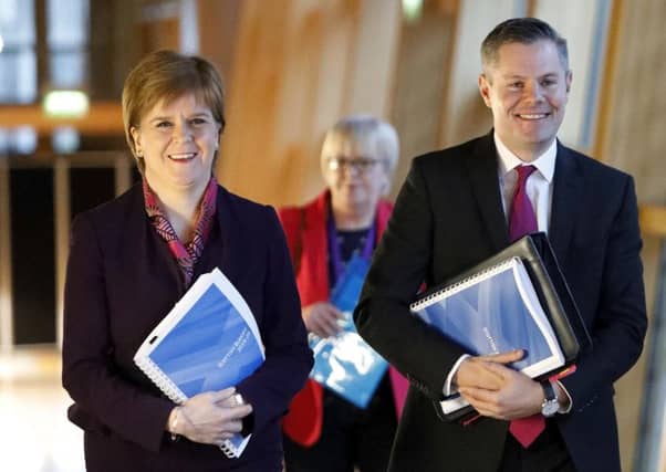 Derek Mackay with Nicola Sturgeon. Picture: PA Wire