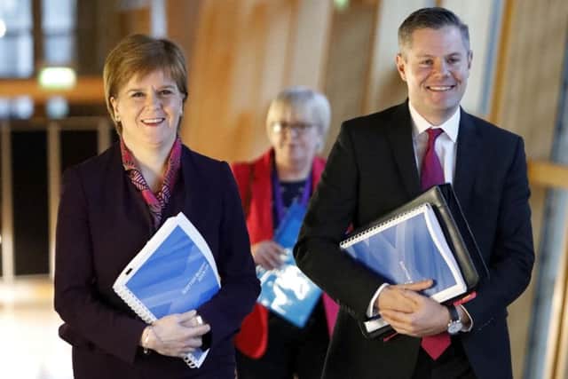 First Minister Nicola Sturgeon and Finance Secretary Derek Mackay on their way to the debate on the Scottish Government's draft spending and tax plans for 2019-20. Picture: PA Wire