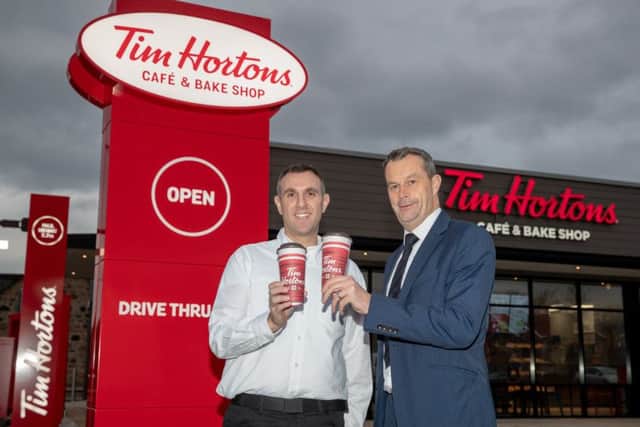 Tim Hortons franchise owner Graeme Tobias outside the new Stenhousemuir store with HSBC relationship director, Grant Bett. Picture: Kenny Smith