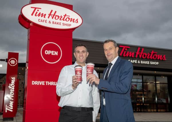 Tim Hortons franchise owner Graeme Tobias outside the new Stenhousemuir store with HSBC relationship director, Grant Bett. Picture: Kenny Smith