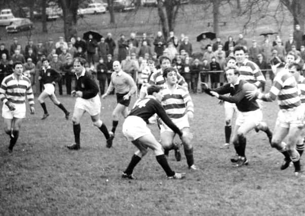 Neil Stevenson prepares to receive the ball as he faces an opponent wearing No. 14 on his jersey