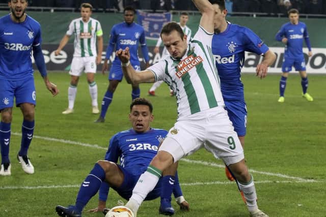Rapid Vienna's Venton Berisha, right, challenge for the ball with James Travernier as Connor Goldson looks on. Picture: AP