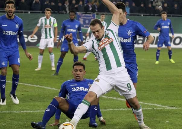 Rapid Vienna's Venton Berisha, right, challenge for the ball with James Travernier as Connor Goldson looks on. Picture: AP