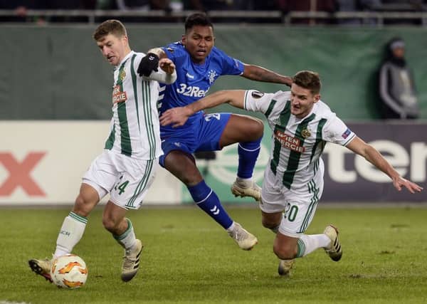 Alfredo Morelos is squeezed out by two opponents last night. Picture: AFP/Getty