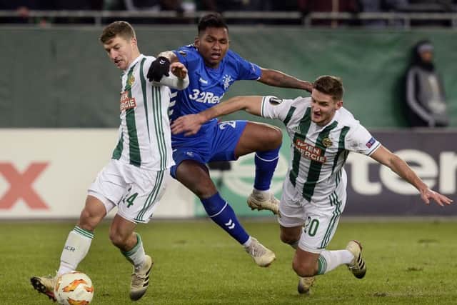 Alfredo Morelos is squeezed out by two opponents last night. Picture: AFP/Getty