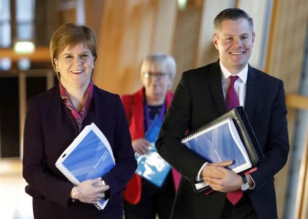 Nicola Sturgeon and Derek Mackay on their way to the debate on the Scottish Government's draft spending and tax plans for 2019-20. Picture: PA