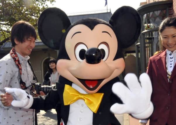 Mickey Mouse greets visitors at Disneyland in Tokyo (Picture: Yoshikazu Tsuno/AFP/Getty Images)