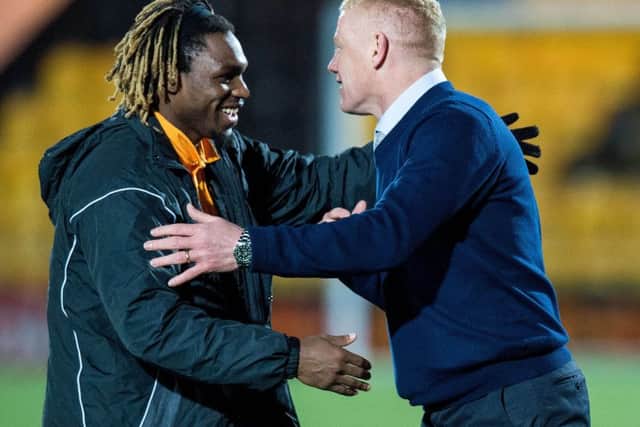 Livingston scorer Dolly Menga celebrates with manager Gary Holt. Picture: SNS