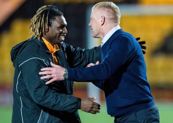Livingston scorer Dolly Menga celebrates with manager Gary Holt. Picture: SNS