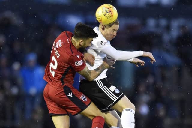 Ross County's Stelios Demetriou competes with Andy Geggan. Pic: SNS/Rob Casey