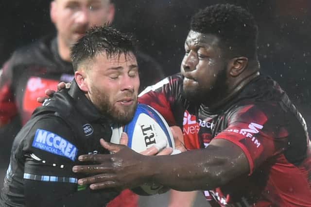 Glasgow's Ali Price finds his progress halted by Lyon's Kevin Yameogo at rain-soaked Scotstoun. Picture: AFP/Getty Images