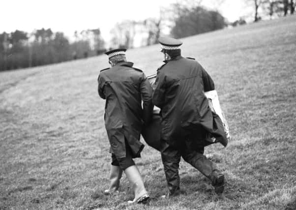 Police gather evidence from the area surrounding the Borders town of Lockerbie, where Pan Am flight 103, a 747 Jumbo jet, crashed after a bomb exploded on board in December 1988.