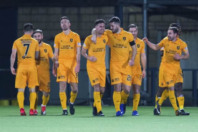 Livingston striker Ryan Hardie (centre left) celebrates his second goal with his teammates. Picture: SNS