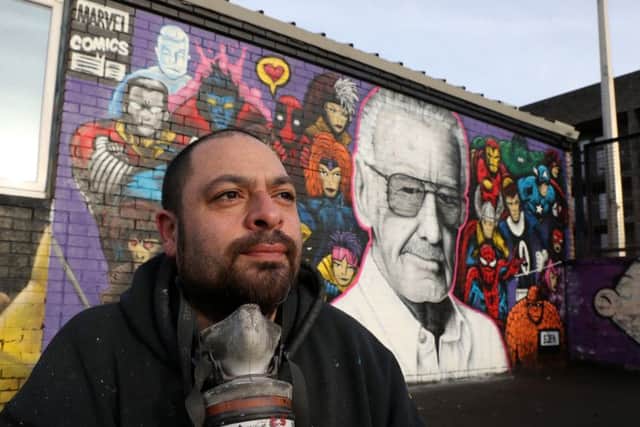 Artist Danny McDermott, known as EJEK, with his recently finished mural of Marvel Comics co-creator Stan Lee. Picture: Andrew Milligan/PA Wire
