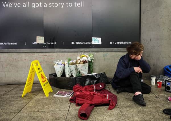 Dawn Hodgson, 45, sits beside a shrine to her friend Gyula Remes at Westminster tube station (Picture: Jack Taylor/Getty)