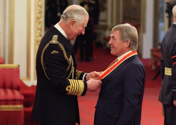 Kenny Dalglish receives his knighhood from the Prince of Wales at Buckingham Palace. Picture: PA