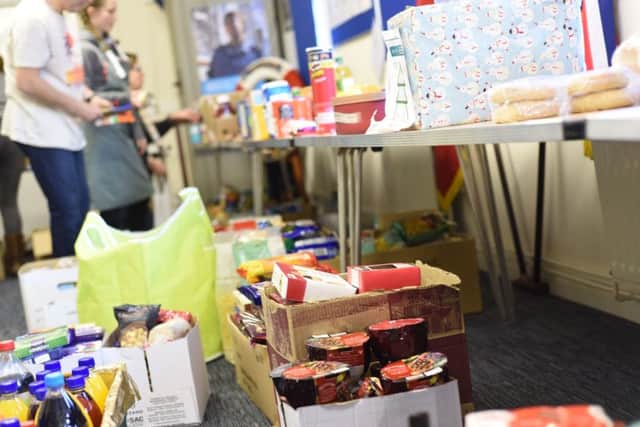 A foodbank sorts out donations from a  reverse advent calendar appeal